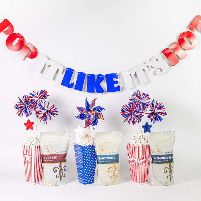 Ruby Red, Baby White and Midnight Blue with large black bowl filled with popped popcorn on red white and blue background - Dell Cove Spices