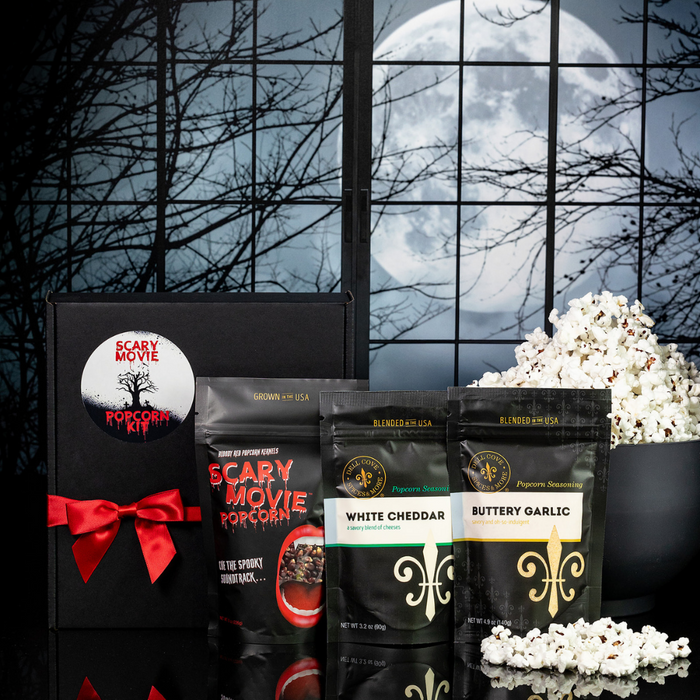 Scary Movie Popcorn Kit with Bloody Red Vampire Popcorn and seasonings on a Halloween party table